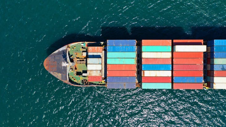 Aerial drone photo of industrial truck size container cargo ship_shutterstock_1726729180