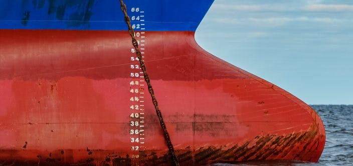 Blue cargo ship moored in still Baltic sea water_shutterstock_585997463