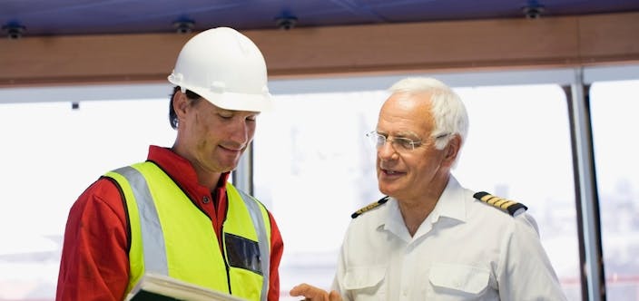 Captain of a ship discussing with a worker_shutterstock_1013460640
