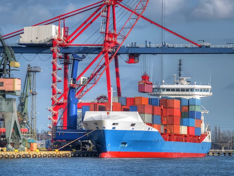 Huge container cargo ship is being unloaded_shutterstock_76623985