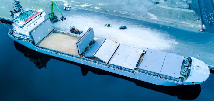 Bulk,Carrier,Ship,At,Port,Loading,Grain,Into,Open,Holds.