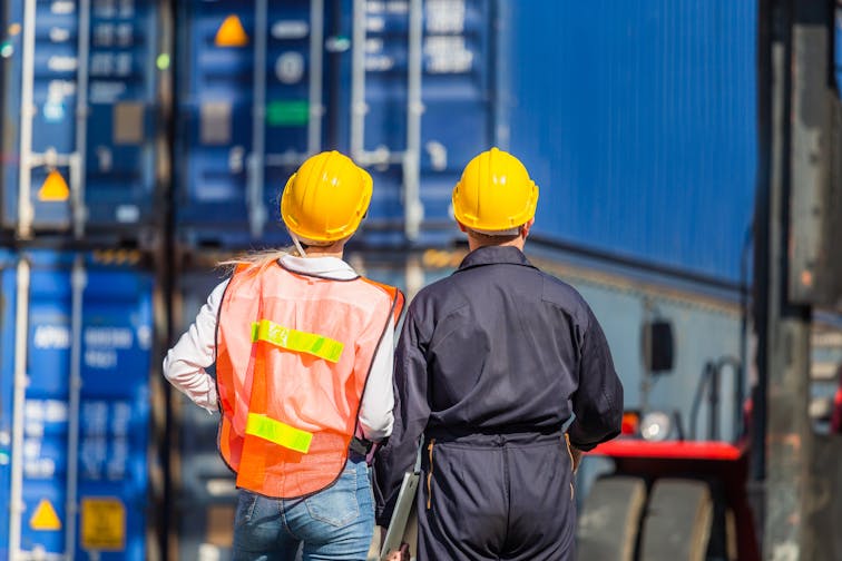 Worker,Man,In,Hardhat,And,Safety,Vest,Holding,Laptop,And