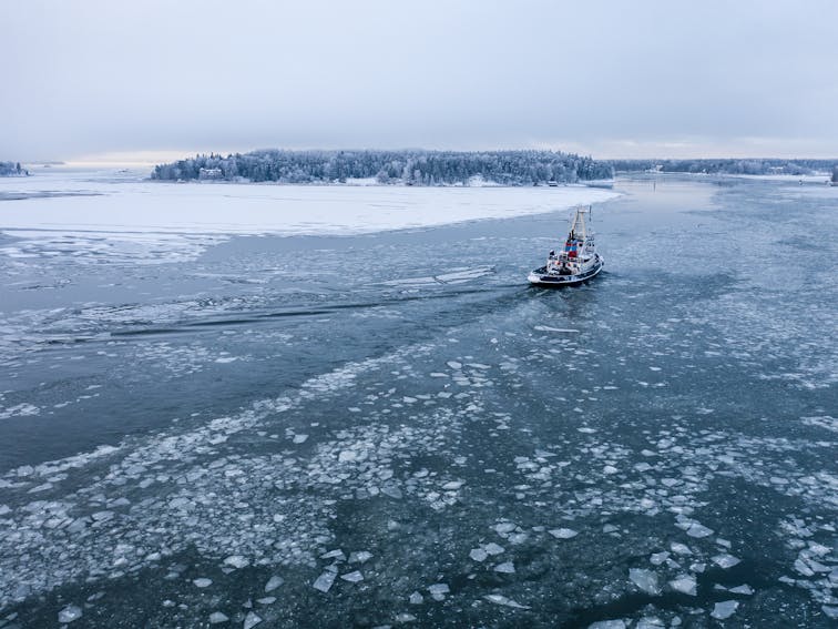 Tug,Boat,Pushing,Through,The,Ice,On,A,Sea,In