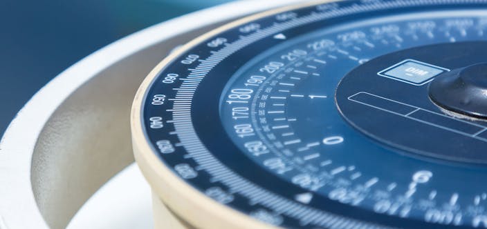 Compass aboard a ship on a blue summer sea.