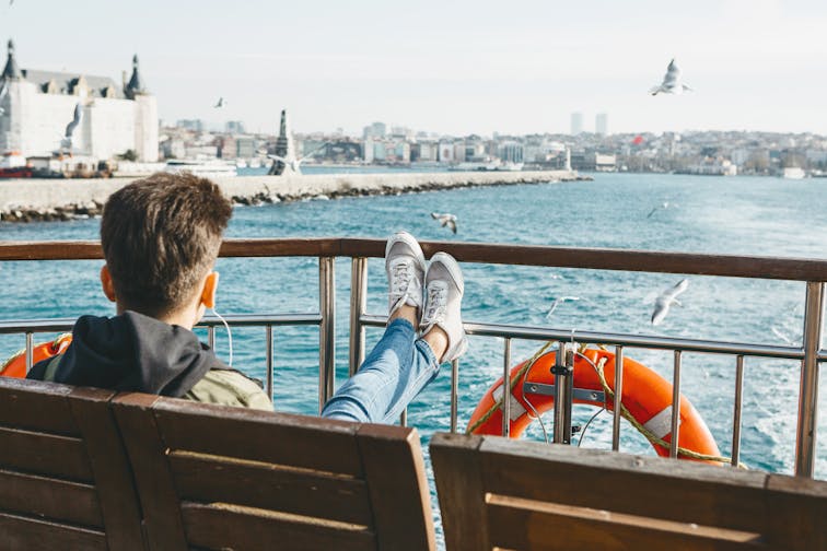 The,Guy,Relaxedly,Sits,On,A,Ferry,Along,The,Bosphorus